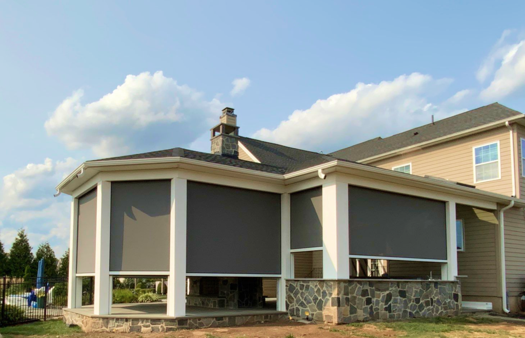 MagnaTrack motorized screens fully deployed on octagonal home addition with stone foundation, Greater Philadelphia PA—M.C. Weeks, Inc.