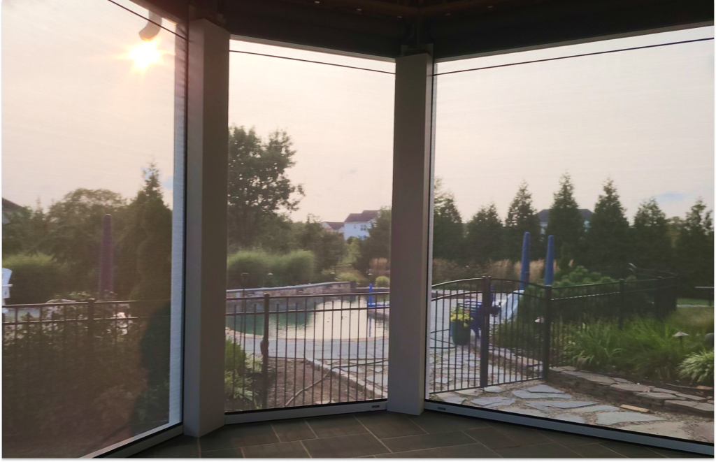 MagnaTrack motorized retractable screens installed on curved porch enclosure overlooking pool, Trappe PA—M.C. Weeks, Inc.